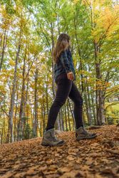 Stylish female teenager in casual outfit at autumn forest