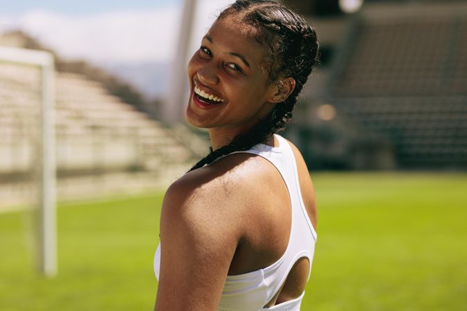 Close-up of a fit female athlete looking over her shoulder and smiling