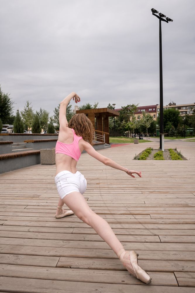 Unrecognizable ballet dancer in city street