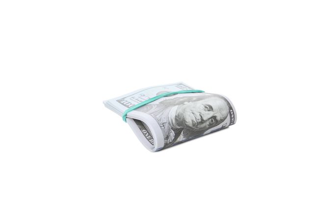 Stacks of American cash money, isolated on light background