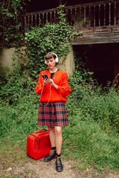 Woman in headphones with suitcase choosing music