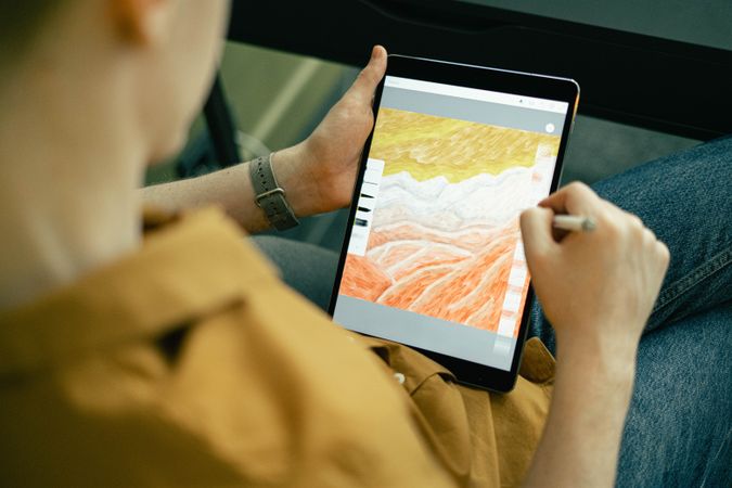 A guy drawing on an computer tablet