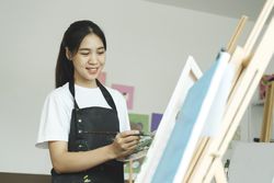 Crafting Inspiration: Female Artist Sketching and Painting in Workshop