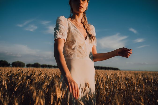 Woman in middle of wheat field