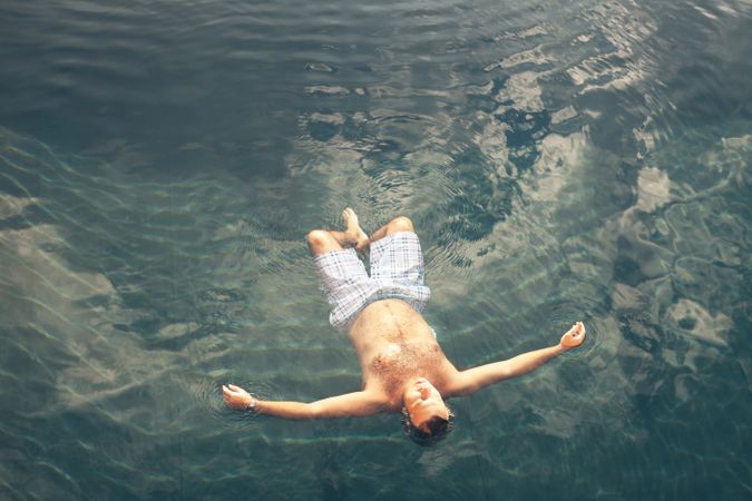 Man swimming in blue water