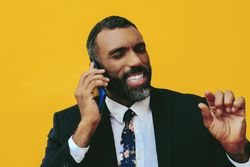 Serious Black businessman having a call on a smartphone screen