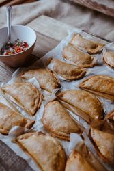 Baking tray with composed freshly baked pies patty