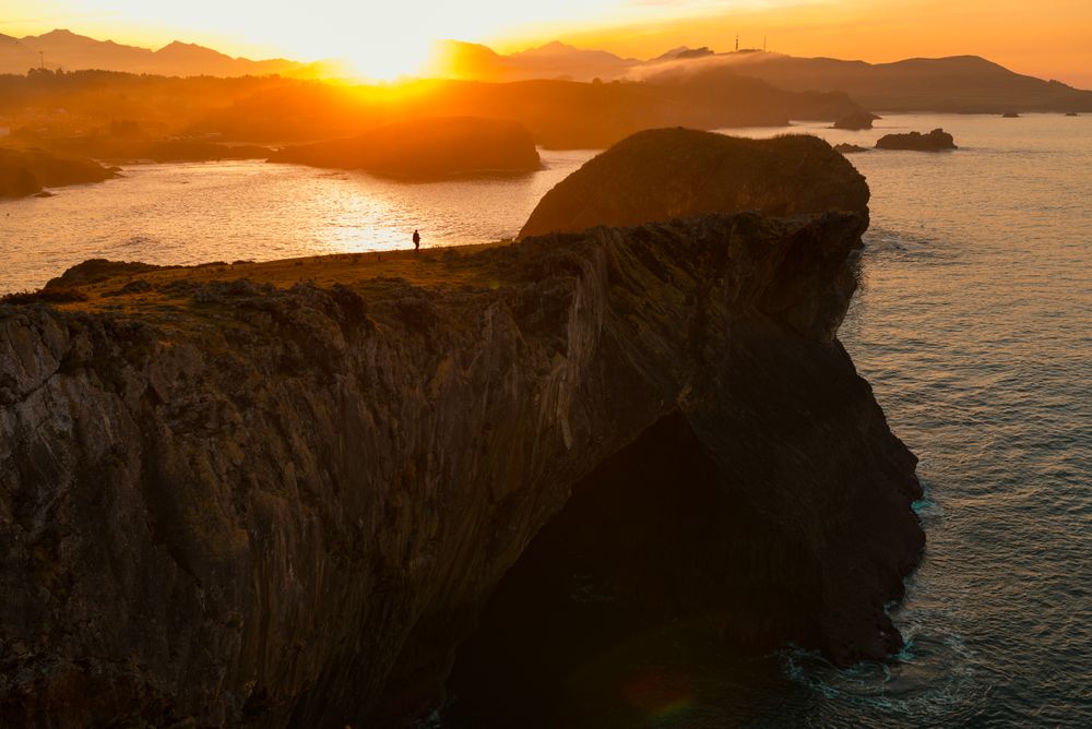 Majestic cliffs of ocean coastline in sunset