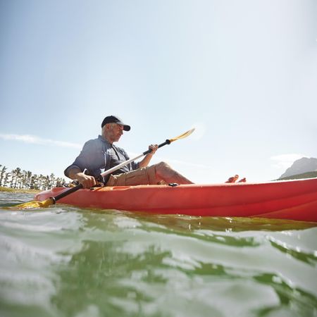 Man kayaking on lake on a summer day