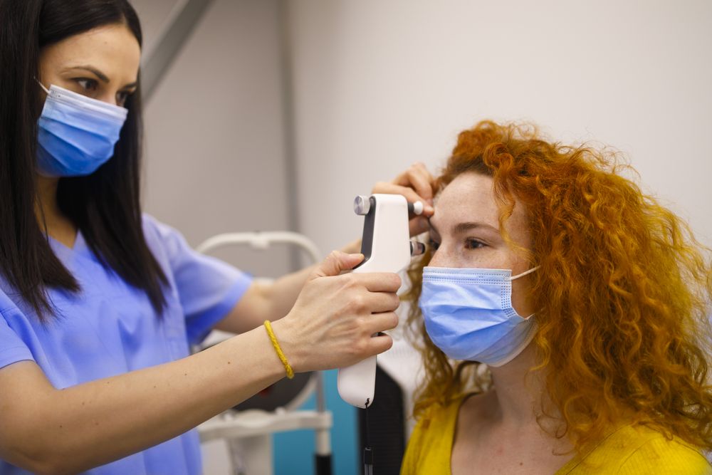 Woman having her eyes checked by optometrist