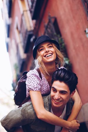 Happy couple having fun while walking in town