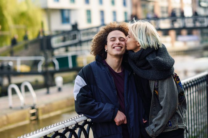 Couple kissing above river in Camden Town, London