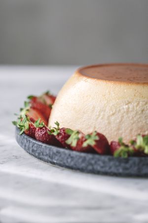 Hand putting cream on flan