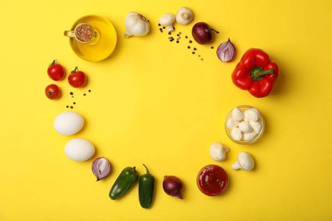 Ingredients for cooking on yellow background, top view