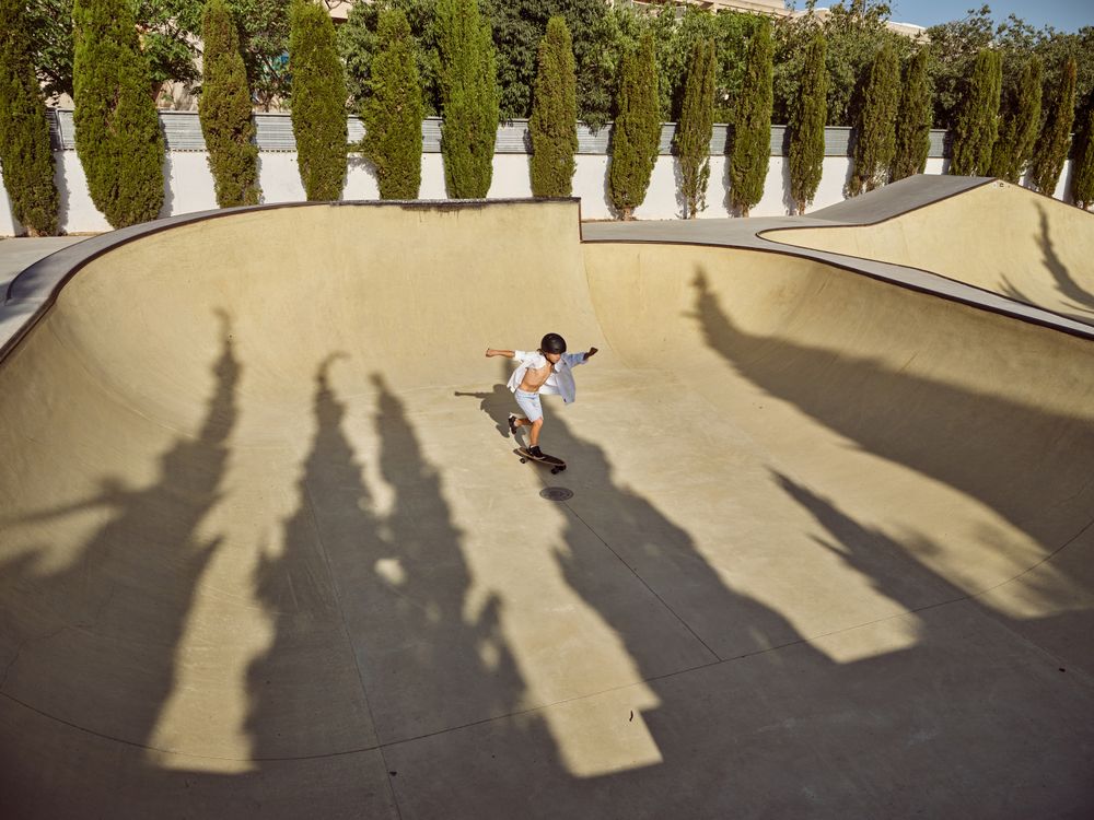Boy riding longboard on sunny day