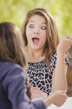 Female Friends Talking Over Drinks Outside