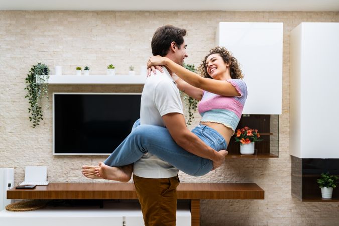 Man and woman embracing in living room