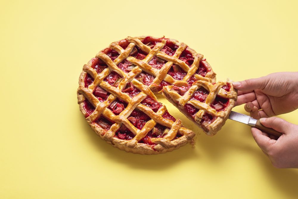 Serving rhubarb and strawberry pie slice