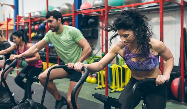 Athletes doing air bike indoor