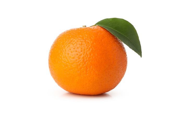 Ripe mandarin with leaves isolated on light background