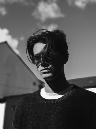 White male model with wavy hair and sunglasses