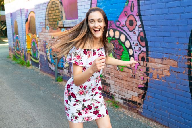 Funny woman laughing and making silly face on street