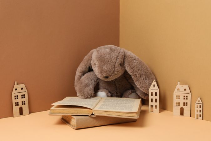 A children's book with toys on a beige background.