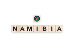 Wooden blocks bearing the name and flag of Namibia. Namibian and South African Culture, national identity, travel, and geography in a copy space design.