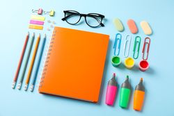 Flat lay composition with school supplies on color background, space for text