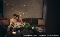 Couple relaxing with smartphone in cozy living room 41l1yg
