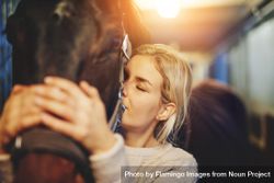 Caring female adult showing affection to her horse companion 48PYq4