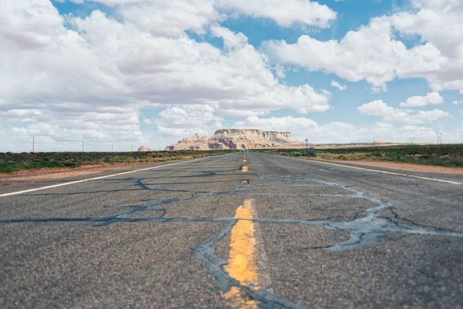 Asphalt road at scenic mountain valley and power line