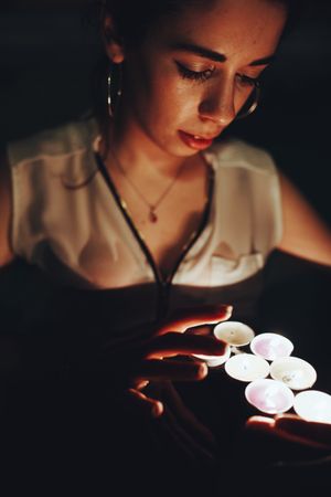 Woman swimming in pool with candles