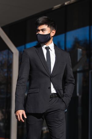 Asian businessman standing in street