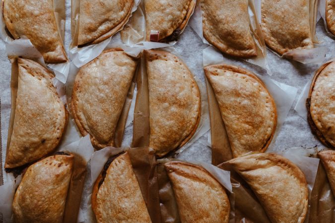 Baking tray with composed freshly baked pies patty