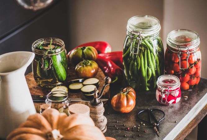 Kitchen counter with glass jars of pickled vegetables on counter