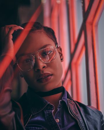 Stylish woman in glasses shot at night