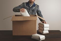 Man packaging coffee beans for shipment