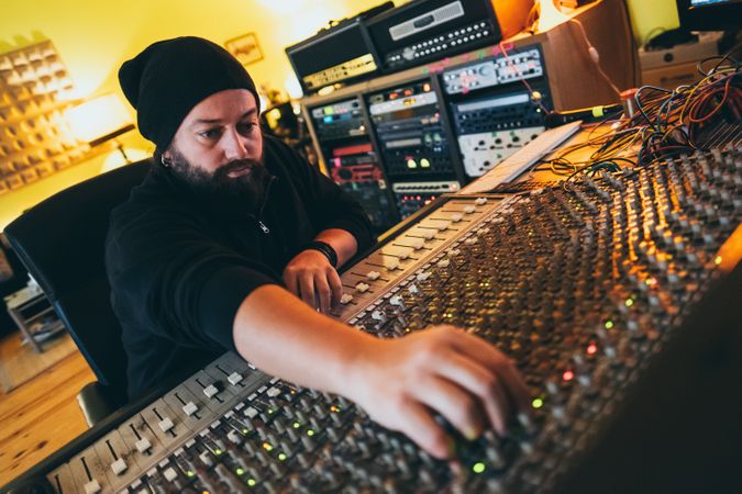 Man in a equalizer instrument in a studio