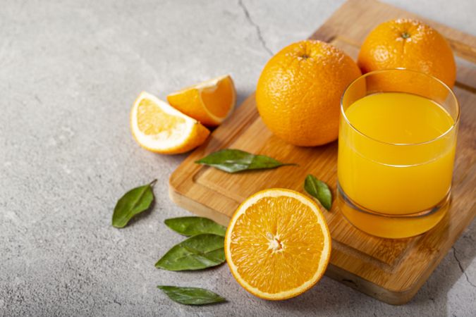 Glass with orange juice on the table.