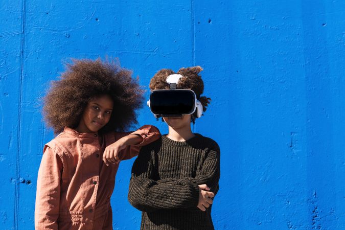 Teen Black friends with VR headset