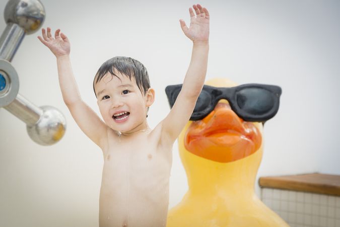 Biracial smiling boy playing at the water park