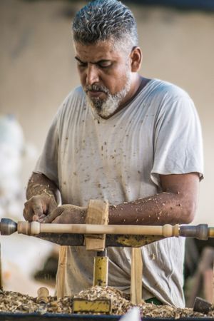 Man using woodworking machine at workplace