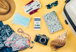 Set with mobile covid passport and beach holiday objects