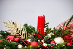 Side view of Christmas festive center piece with fir and gold & red ornaments