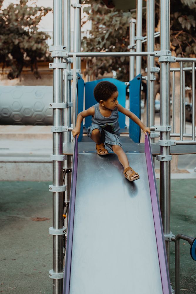 Smiling Black boy on slide