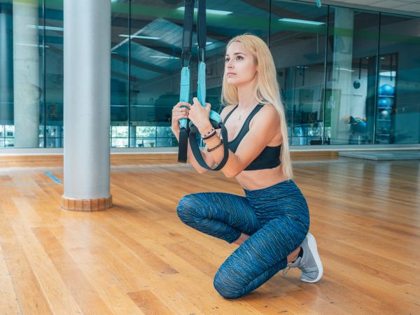 Sportswoman with training band in gym