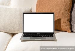 Laptop mockup on beige couch at home 5zAeA0