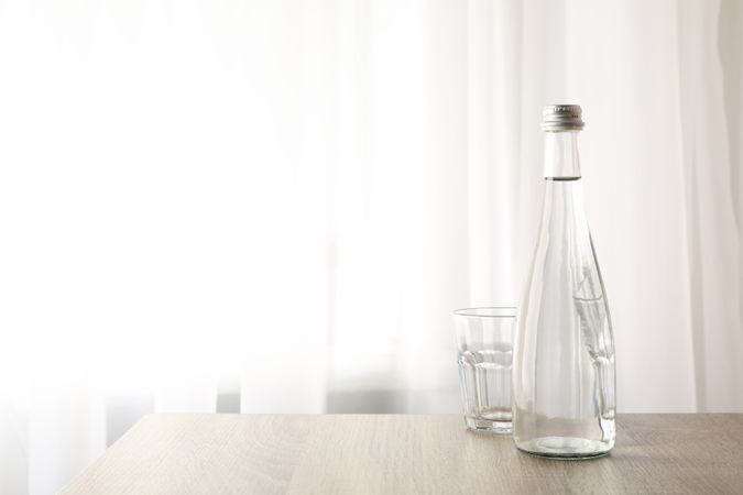 Water bottle with glass near window