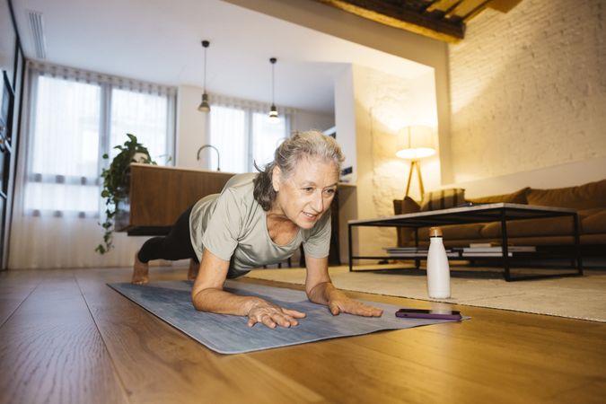 Older Woman doing yoga at home